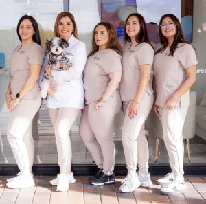 Dr. Roman and her team posing together in front of the office